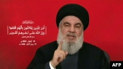 A photo taken from Hezbollah's Al-Manar TV video shows the Lebanese militant group's chief, Hassan Nasrallah, addressing the nation from an undisclosed location on Sept. 19, 2024.