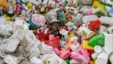 A worker sorts through plastic waste at a recycling site on the outskirts in Hanoi, Vietnam.