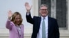 Italian Prime Minister Giorgia Meloni and British Prime Minister Keir Starmer wave as they walk in the garden of Villa Doria Pamphili after their meeting on Sept. 16, 2024 in Rome. 