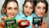 FILE - Three women hold the pager 'Quix' in Hannover, Germany, March 18, 1997. Pagers of many brands were status symbols decades before the smartphone wiped them from popular culture. But the devices remain a vital means of communication in some areas, such as healthcare.