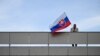 Чоловік розмахує державним прапором Словаччини біля університетської лікарні імені Ф. Д. Рузвельта, де лікується поранений прем’єр-міністр Словаччини Роберт Фіцо. 59-річний Фіцо перебуває у важкому стані після замаху. Банськa Бистриця, 16 травня 2024 року. (AP)