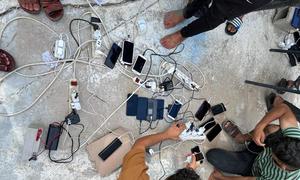 People caught up in the conflict in Gaza recharge their mobile phones.