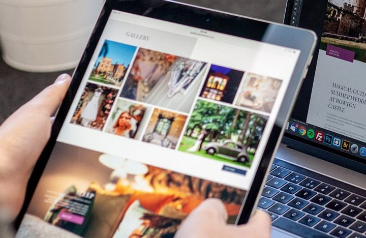 View of someone holding an ipad infront of a laptop, both screens displaying the Rowton Castle website