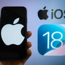 The Apple logo is seen with the iOS 18 operating system logo in the background on a mobile device