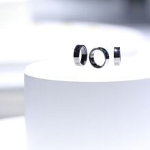 three platinum samsung galaxy rings on a white pedestal