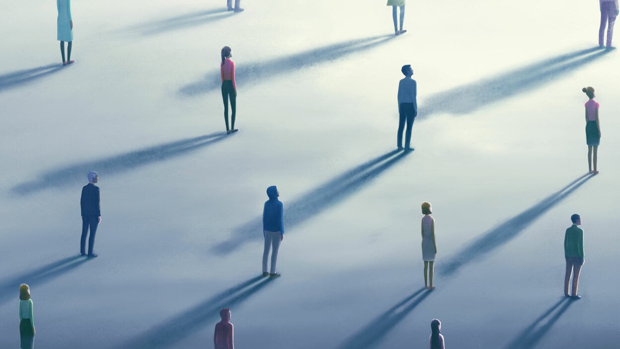 A group of people standing at a distance from each other.