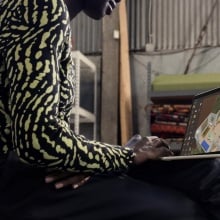 person working on m3 macbook air perched on their lap