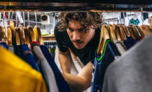 Jack Innanen looking through shirts in a thrift store in Bushwick, New York