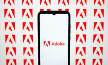 adobe logo on a smartphone against a background of adobe icons