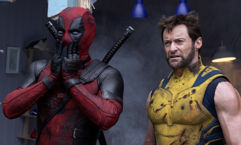 Deadpool and Wolverine standing together in a grey room.