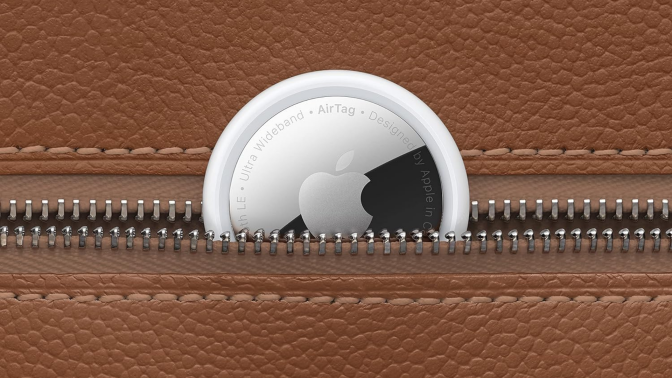 An AirTag peeking out of a leather wallet