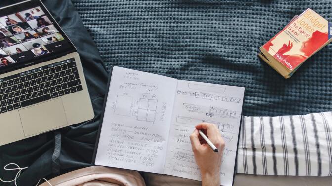 Notebook and laptop on bed