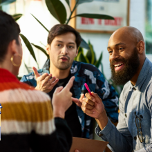 Multi ethnic group sharing ideas in office