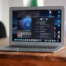 Gray MacBook Air computer resting on a table in an open position