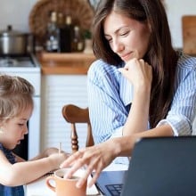 woman helping child at computer