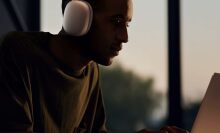 A man wears Apple AirPods Max headphones 