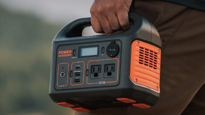 close-up of man holding jackery explorer power station