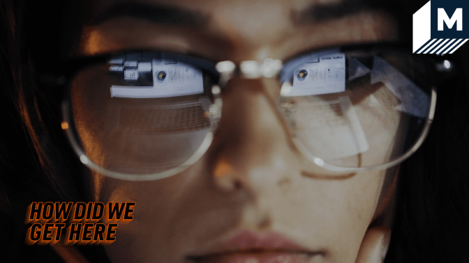 woman wearing glasses with a computer screen in their reflection