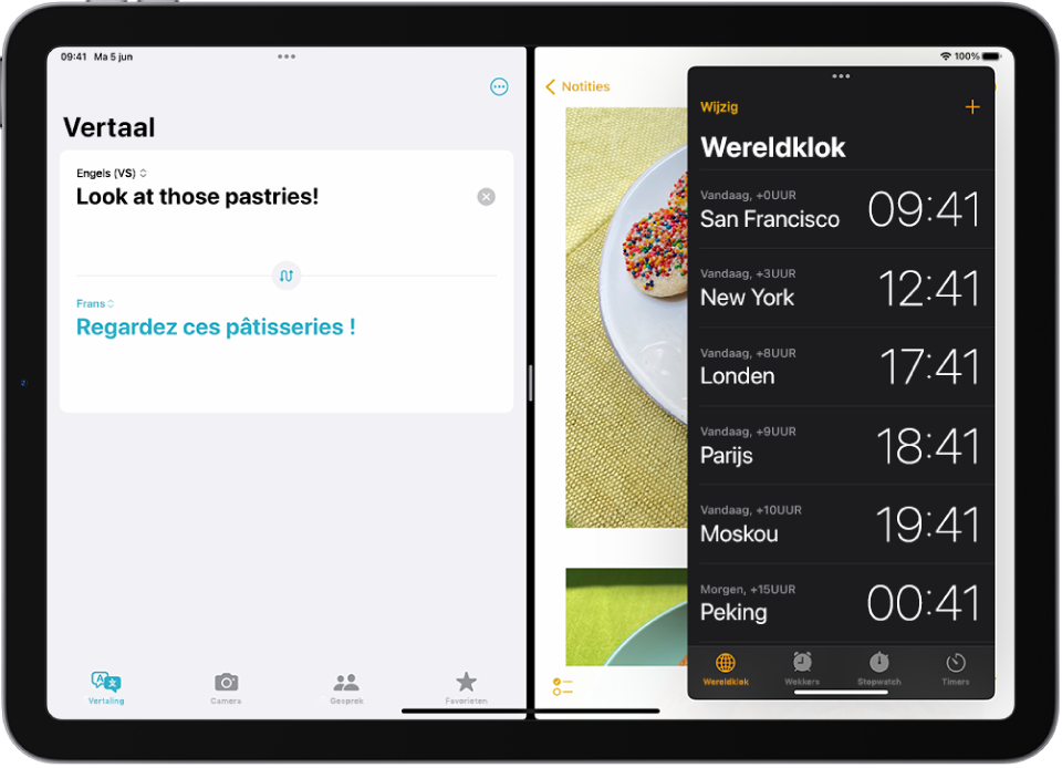 De Vertaal-app is open aan de linkerkant van het scherm, Notities is open aan de rechterkant en Klok is open in een Slide Over-venster dat Notities gedeeltelijk bedekt.