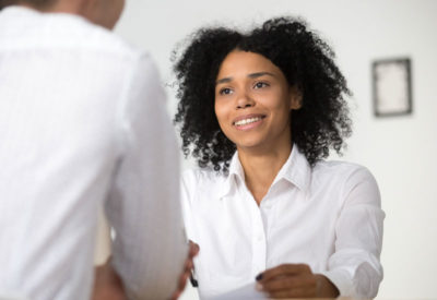 woman in professional attire, smiling