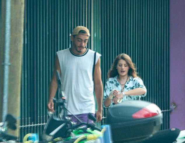 Georgia (right), who fought off a crocodile as it dragged her twin sister into a Mexican lagoon, has been seen walking near the hospital in between visits