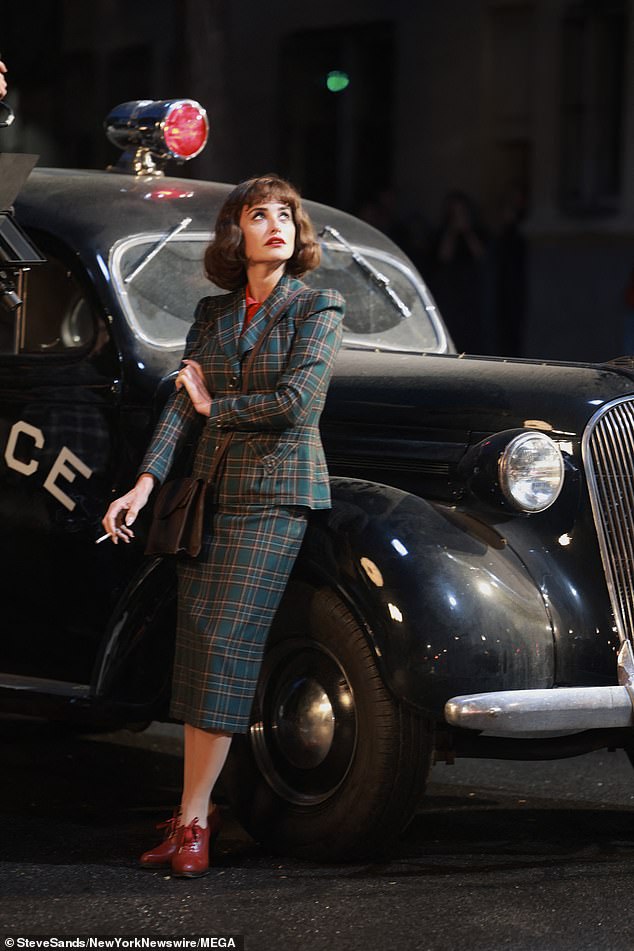 Her checked suit comprised a fitted jacket with pockets and a midi skirt while she paired the look with red lace-up heeled brogues