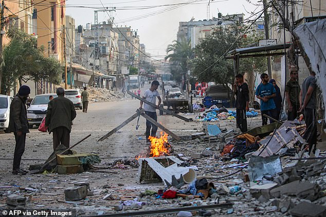 Palestinians salvage items from the rubble of a family house that was hit overnight in Israeli bombardment in the Tal al-Sultan neighbourhood of Rafah in southern Gaza on May 20, 2024