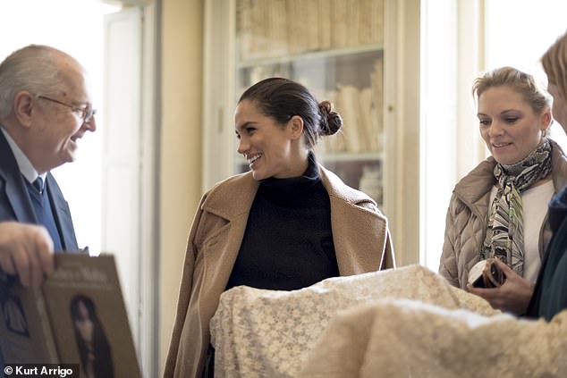 Meghan laughs as the 9th Marquis de Piro shows her his books and 'aristocratic bric-a-brac'