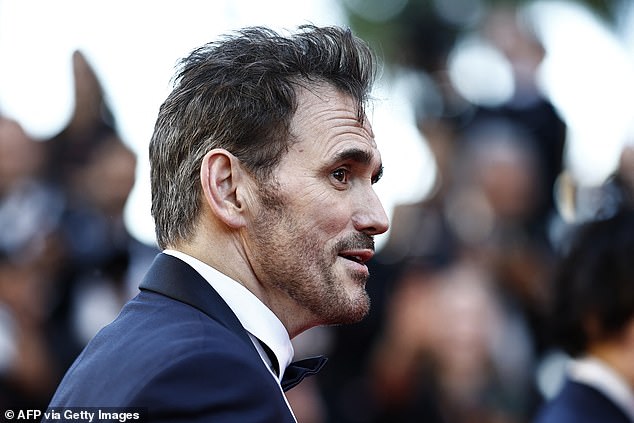 His hair looked more gray in the back as he wore a tuxedo in Cannes on Tuesday