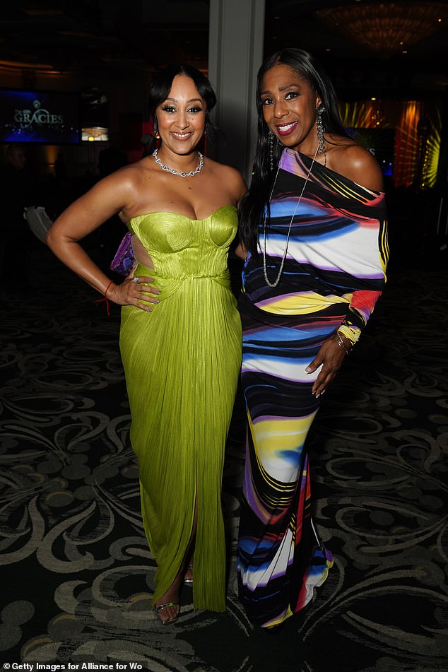 Backstage, the Baker's Dozen host mingled with A Different World alum Dawnn Lewis (R), who bared her shoulder in a coloful gown