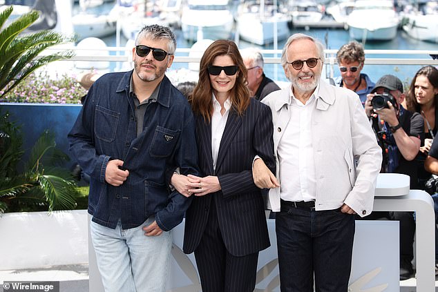 Him and Christophe were also joined by Chiaro Mastroianni, 51, (center) who cut a chic figure in a navy pinstripe suit