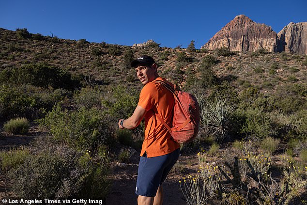 Climber Alex Honnold looks over his shoulder on the approach to the Rainbow Wall in Red Rock Canyon National Conservation Area Monday, May 13, 2024 in Las Vegas