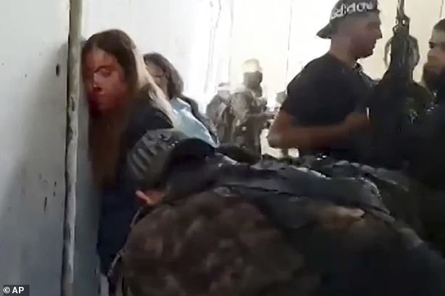 Israeli female soldiers from the Nahal Oz military base are placed against the wall and shackled by members of Hamas after they were taken captive on Oct. 7, 2023