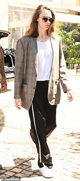 She looked stylish in black and white pinstripe trousers, paired with a white T-shirt and vintage tweed jacket