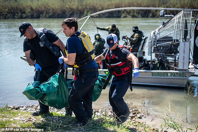 Firefighters (from L) Rodrigo Pineda, William Dorsey and Lt. Julio Valdes of the Eagle Pass Fire Department recover a body from the Rio Grande river on March 1, 2024 in Eagle Pass, Texas. Eagle Pass Fire and EMS assisted with a body recovery of a suspected drowned migrant. The Fire Department has seen an increase in calls for assistance from Border Patrol as the number of migrants crossing has steadily gone up in the area