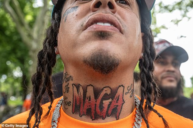 A MAGA fan shows off his neck tattoo as he awaits the arrival of the former president