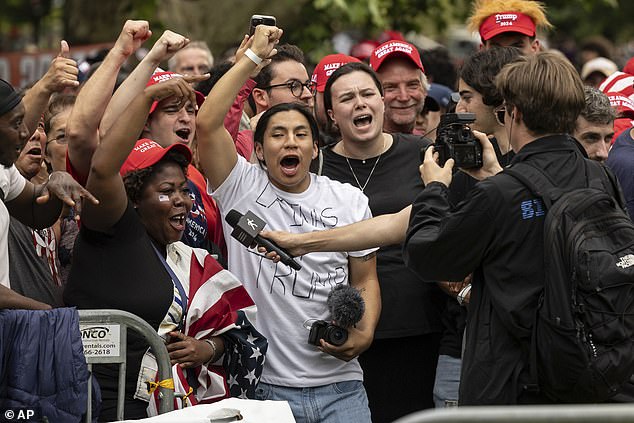 MAGA fans cheer as they await the arrival of the former president