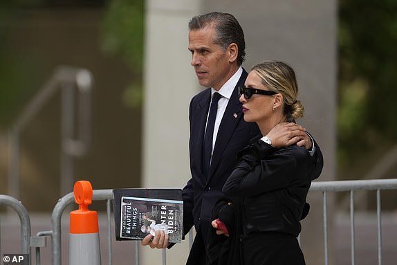 Hunter Biden, left, departs from federal court with his wife, Melissa Cohen Biden, Wednesday, June 5, 2024, in Wilmington, Del. (AP Photo/Matt Slocum)