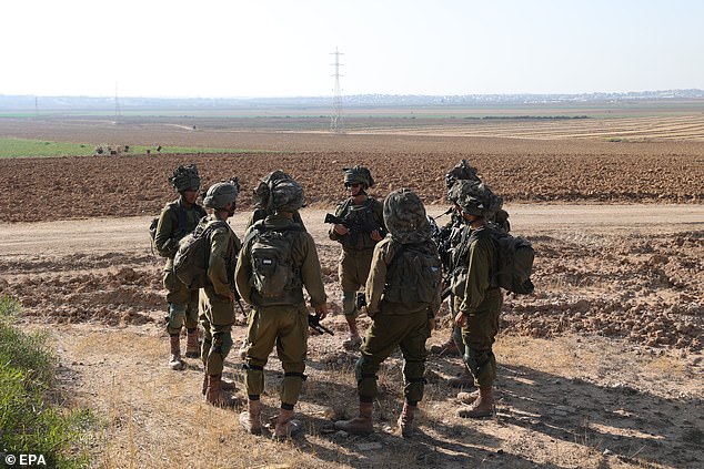 Israeli soldiers patrol along the border with the Gaza Strip, at an undisclosed location in southern Israel, 13 June 2024