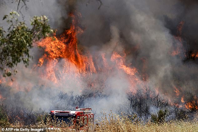 Firefighters deploy to extinguish a blaze after rockets fired from south Lebanon landed near Kfar Szold in the Upper Galilee in northern Israel on June 14, 2024