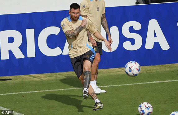 Argentina's Lionel Messi kicks the ball as he works on a drill during training for a Copa AmÃ©rica soccer match, Wednesday, June 19, 2024, in Kennesaw, Ga. Argentina plays against Canada on Thursday in Atlanta. (Miguel Martinez/Atlanta Journal-Constitution via AP)