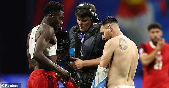 Soccer Football - Copa America 2024 - Group A - Argentina v Canada - Mercedes-Benz Stadium, Atlanta, Georgia, United States - June 20, 2024 Argentina's Lionel Messi and Canada's Alphonso Davies after the match REUTERS/Agustin Marcarian