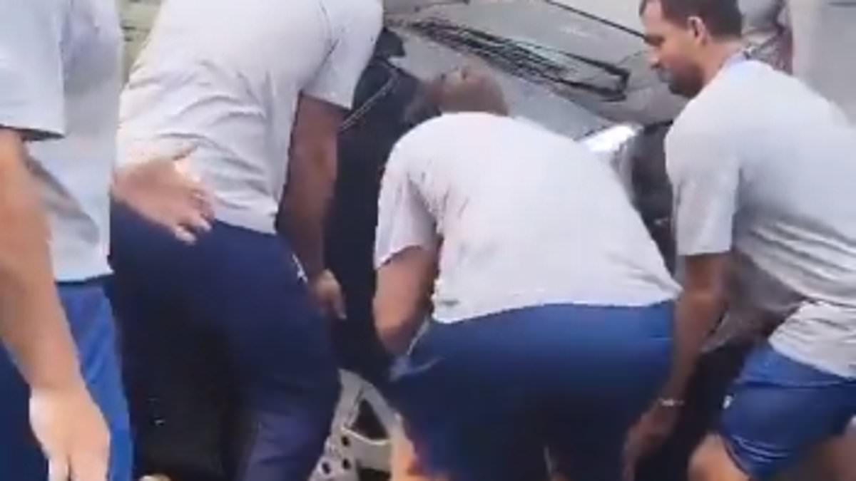 Hilarious moment Greek Olympic water polo team lift badly parked car so their bus can squeeze down narrow Paris street