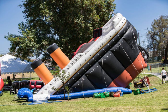 An inflatable Titanic in the middle of a park.