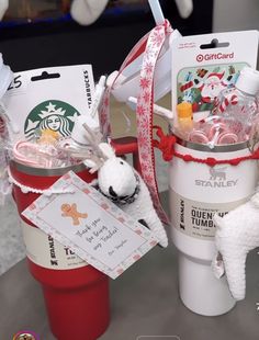 two starbucks cups filled with candy and stuffed animals