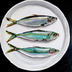 three fish on a white plate sitting on a black and white tablecloth with the words steetarasov above it