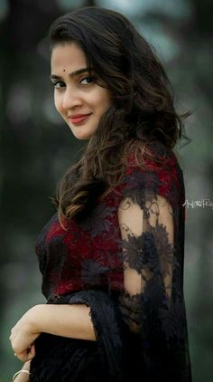 a woman with long hair wearing a black and red dress