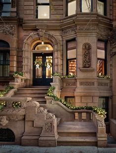 an old building with christmas decorations on the steps