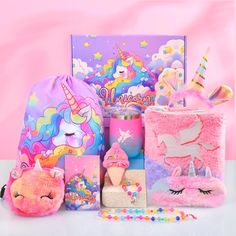 an assortment of stuffed animals and toys on a pink background with unicorns in the background