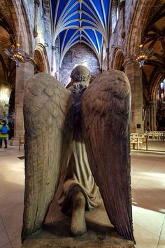 an angel statue sitting in the middle of a building